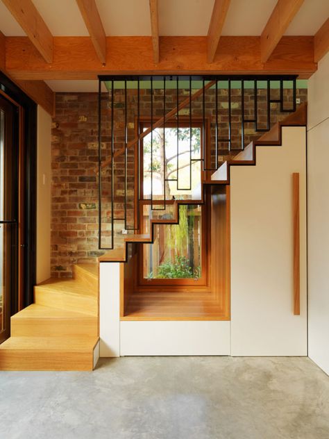 This modern house has a cut-out underneath the stairs to allow the light from the window to flow through to the interior. #Stairs #InteriorDesign #Window Light Stairs, Built In Window Seat, Stairs Window, Stairs Design Interior, Stairs Architecture, Concrete Stairs, Stairs Design Modern, Floating Stairs, Staircase Decor