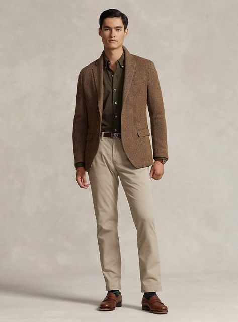 Experience timeless style with a textured brown herringbone blazer paired with an olive shirt and tan chinos, finished with elegant brown loafers. Perfect for those seeking a sophisticated yet approachable look. Brown Sports Jacket Outfit Men, Olive Blazer Outfit, Sports Jacket Outfit Men, Tan Loafers Outfit, Brown Herringbone Blazer, Sports Jacket Outfit, Olive Blazer, Olive Chinos, Jacket Outfit Men