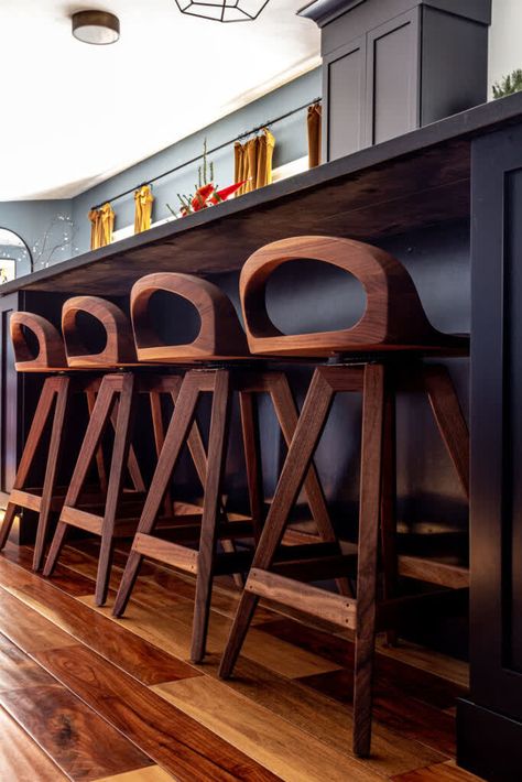 Close up of a row of walnut counter stools in front of a black island Kitchen Island 2023, Long Dining Room Tables, Picture Walls, Custom Island, Blue Bookcase, Soapstone Counters, White Quartz Counter, Black Island, Custom Kitchen Island