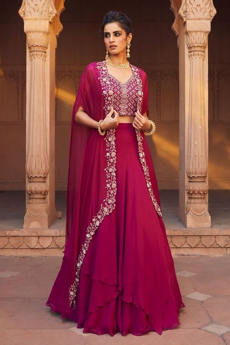 Buy #raspberry #lehenga with asymmetrical hemline. Comes with #embellished #cape and #blouse by #CharuandVasundhara at #Aza #Fashions Shop online now at #Azafashions.com Call +91 99870 70743 or email contactus@azafashions.com for enquiries. #wedding #festive #ethnic #tradional #shopping #shoponline #party #reception #bride Cape Lehenga, Lehenga Designs Simple, Gaun Fashion, Indo Western Dress, Designer Party Wear Dresses, Designer Dresses Casual, Party Wear Indian Dresses, Stylish Dress Book, Lehenga Designs