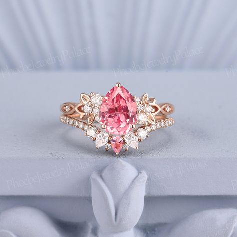 Unique Peach Pink Sapphire Engagement Ring Set Vintage Pear Wedding Rings for Women Gold Art Deco Moissanite Leaf Rings Handmade Gift Custom PRODUCT SUMMARY Metal Type: yellow, white or rose solid 10k, 14K or 18k gold. Size: All sizes are available, contact me if they do not contain the size you want in the drop-down menu. ☪☪Engagement ring ⚜Center Stone - Lab grown pink peach sapphire Cut - Pear Size - 6x8mm ⚜Side Stone - Moissanite  Cut - Round cut Weight - 0.12ct ⚜Band width - 1.7mm ☪☪Wedding Pink Sapphire Engagement Ring With Wedding Band, Pink Princess Ring, Peach Sapphire Ring, Pink Rings Engagement, Wedding Rings Pink, Wedding Rings Pink Sapphire, Leaf Rings, Pink Sapphire Engagement Ring, Rings For Women Gold