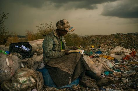 "A woman sits on bags of waste she has salvaged, at the Dandora municipal dump, outside Nairobi, Kenya. She said that she enjoys looking at books, even industrial catalogues, as a break from picking up garbage. Image & Caption by: Micah Albert" #heartbreak #books #illiteracy #poverty British Journal Of Photography, Human Rights Watch, Human Dignity, World Press, Nairobi Kenya, Photo Awards, Contest Winner, Woman Reading, Six Feet Under