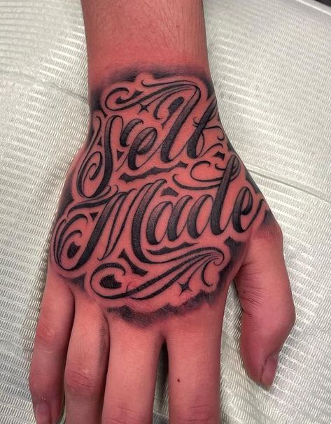 150 Hand Tattoos: Ideas and Meanings | Art and Design Back Hand Tattoos For Guys, Small Tattoos With Meaning For Men Guys, Self Made Hand Tattoo, Black Hand Tattoos Men, Male Hand Tattoos Ideas, Words Hand Tattoo, Hand Tattoo Stencils For Men, Hand Tattoos Writing, Hand Tattoo Words