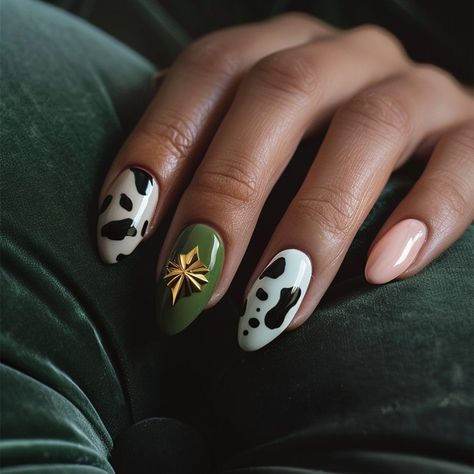 A stunning blend of earthy tones and bold patterns, this nail art captures the essence of modern sophistication. The rich olive green, accentuated by a striking gold embellishment, adds a touch of luxe, while the playful cow print on crisp white nails brings in a trendy, whimsical vibe. The neutral peach base ties the whole look together, offering a balance between boldness and subtlety. This design perfectly merges current trends, with the cow print maintaining its popularity in fashion, wh... Gold Embellishment, Bold Patterns, Current Trends, The Cow, Cow Print, Earthy Tones, White Nails, In Fashion, Olive Green