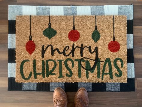 "Welcome your holiday guests with this festive \"Merry Christmas\" outdoor doormat.  Doormats are hand painted with outdoor-rated paint. These coir doormats measure approximately 18\"x30\" in size and have non-slip backing. This mat is suitable for outdoor use but keeping it out of rain and direct sunlight will prolong the life of the design. Listing includes one coir doormat only. Listing photos include display options for your front entry using this doormat." Christmas Outdoor Rug Ideas, Door Mat Ideas Christmas, Christmas Outdoor Mats, Christmas Painted Doormat, Christmas Rugs Outdoor Diy, Christmas Rug Painting Ideas, Christmas Door Mat Ideas Diy, Diy Painted Doormat Christmas, Holiday Door Mat