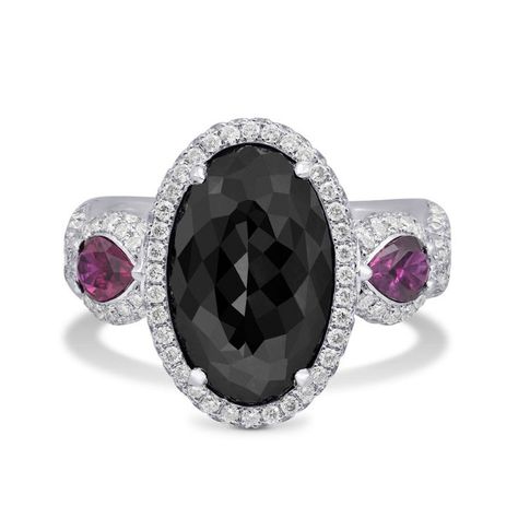 The Black Oval Diamond and Ruby Ring, number six in our article featuring 16 Unique Black Diamond Engagement Rings, pairs a bold black diamond with striking rubies set in an elegant design. This unique combination brings a modern twist to traditional luxury, making it a standout choice for those seeking something truly different. Click here to learn more about this captivating ring and explore the full range of unique black diamond rings. Unique Black Diamond Engagement Ring, Black Diamond Ring Set, Diamond And Ruby Ring, Ring With Ruby, Titanic Jewelry, How To Wear Rings, Black Gems, Black Diamond Engagement, Black Diamond Ring Engagement