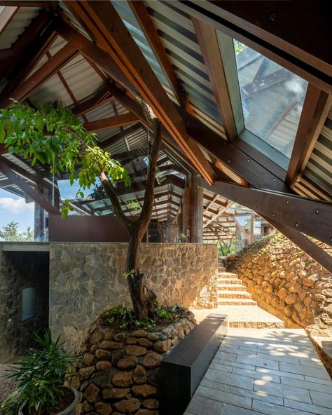 Malik Architecture has created the Lateral Verandah House in India. Malik Architecture, Wrap Around Verandah, Verandah House, Door Shades, Indian House, Wooden Terrace, Basalt Stone, Hillside Landscaping, New Architecture