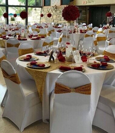 Red Cream And Gold Party Decor, Red Gold And Ivory Wedding Decor, Red White And Gold Table Setting, White Chair Covers With Gold Sash, White And Red Party Decorations, Red And Gold Wedding Table Decor, Red Gold White Wedding Theme, Red And White Reception, Red And Gold Table Decorations