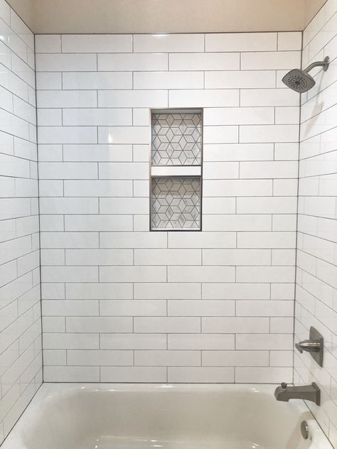 White subway tile with gray grout.  Shower niche. White Subway Tile With Gray Grout Bath, White Ceramic Shower Tile, White Subway Tile With Niche, Subway Tile Shower With Niche, White Tile With Gray Grout, Tv Bath, Grey Grout Bathroom, Subway Tile Shower Niche, Updating Bathroom