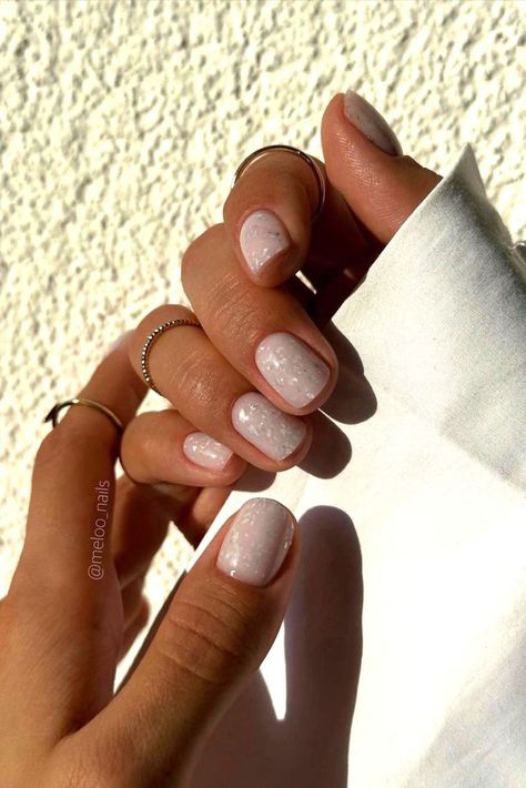 These minimalist nails by @meloo_nails (IG) feature a soft milky white base with a subtle touch of white glitter, creating a simple yet elegant look. Perfect for short nails, this design adds a hint of sparkle while staying understated and chic. Discover the season’s top 25 white fall nail ideas, from cozy minimalist designs to chic, polished looks that match any autumn outfit. Get inspired and learn how to create these timeless styles here! Milky White Nails With Sparkle, Milky Sparkle Nails, Milky Base Nails, Milky White Nails Glitter, Short White Christmas Nails, Subtle Sparkle Nails, Milky White Glitter Nails, White New Years Nails, Short Milky White Nails