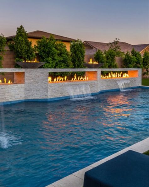 Modern Pool With Fire Feature, In Ground Pool Water Features, Fire Features Pool, Pool Waterfall Wall Tile, Modern Pool With Waterfall, Sloped Hardscape, Modern Pool Waterfall, Rectangular Pool Landscaping, Pool Waterfall Wall