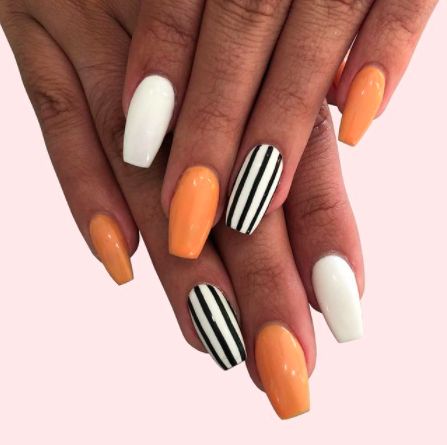 Orange Nails: Beetlejuice Stripes. Alternating orange and white nails with black striped accents. Click through for 26 orange nail ideas. #orangenailideas #orangenails #nailideas IG: @thecosmostudio Halloween Nails Diy, Holloween Nails, Halloween Acrylic Nails, Cute Halloween Nails, Seasonal Nails, Fall Acrylic Nails, Nails 2021, Cute Gel Nails, Nails Fall