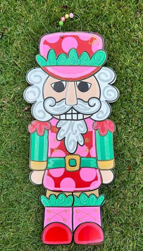 Retro Nutcracker door hanger!! too cute! perfect for your door decor for the holiday season!! Nutcracker Door Sign, Manger Door Hanger, Nutcracker Door Decorating Ideas, Christmas Painted Door Hangers, Pink Christmas Door Hanger, Nutcracker Window Painting, Diy Nutcracker Ornament, Nutcracker Door Decorations, Nutcracker Door Hanger