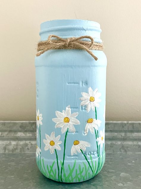 Unlock your creativity with our step-by-step tutorial on painting mason jars. Learn the secrets to stunning designs and personalized decor. Perfect for #DIYlovers, #craftingenthusiasts, and #homedecorinspiration. Start your #masonjarproject today and bring your artistic vision to life! #paintingtips #homedecorideas #DIYcrafts Painting On Glass Jars Ideas, Cute Mason Jar Painting Ideas, Painting Jars Ideas, Jar Painting Ideas Cute Easy, Paint Bottle Art, Jar Painting Ideas Cute, Diy Vase Painting, Jar Painting Ideas, Mason Jar Painting Ideas