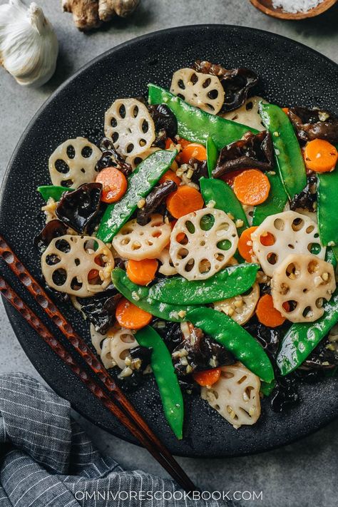 Stir fried lotus root, carrot, snow peas and wood ear mushrooms are tossed in a light savory sauce with a lot of garlic and ginger. It’s a dish that celebrates the spring. It’s super quick and easy to put together, making it the perfect side dish for your dinner. {Vegan, Gluten-Free Adaptable} Chinese Carrots, Fried Lotus Root, Lotus Root Recipe, Vegan Stir Fry, Cantonese Food, Cantonese Cuisine, Garlic And Ginger, Authentic Chinese Recipes, Veg Food