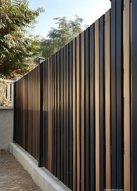 25 Stunning Picket Fence Ideas That Will Transform Your Yard 45 Black Wood Fence Backyards, Black Metal And Wood Fence, Vertical Privacy Fence Ideas, Side Gates Ideas Modern, Fence Design Front Yard, Vertical Fence Ideas, Modern Privacy Fence Ideas, Contemporary Fence Design, Metal Fence Ideas