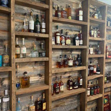 Home bar with bourbon display shelves using reclaimed barn wood Small Bar Display, Floating Shelves For Liquor Bottles, Shelving For Liquor Bottles, Small Rustic Bar Ideas, Wine Cellar Shelving, Liquor Bottle Shelf Display Diy, Bar For Basement Ideas, Wall Bar Shelves, Basement Bar Liquor Display