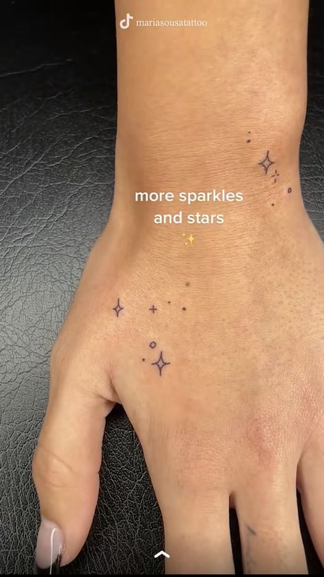 Sparkle Tattoos On Hand, Micro Arm Tattoo, Fairy Dust Tattoo Stars, Ken Eurich Hand Tattoos, Sparkling Tattoo Ideas, Galinda Tattoos, Finger Tattoos Sparkle, 5 Star Tattoo Designs, Earring Tattoos For Women