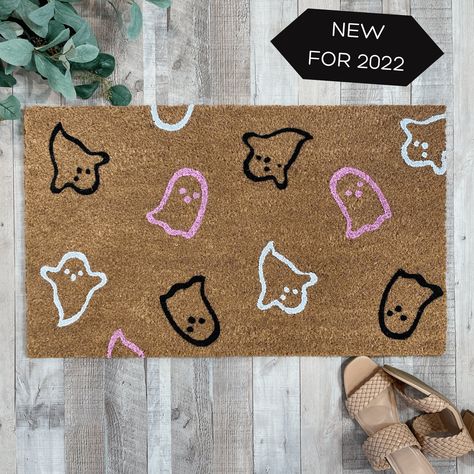 "Our special edition pink 'Ghosts Galore' doormat is the perfect way to create a spooky Halloween themed entry way for all of your  guests! Our welcome mats are each hand-painted and made just for you! Available in 3 sizes: Standard, 18x30 inches, Half Round 24x36 inches and Oversized, 24x36 inches 🍂Production time is 5-7 business days prior to shipping. Shipping is UPS Ground service. 🍂This listing is for the hand painted doormat only, you can pair our doormat with our buffalo check rug avail Diy Spooky Mat, Ghost Welcome Mat, Spooky Welcome Mat, Rug Painting Ideas, Halloween Rugs Ideas, Spooky Doormat Diy, Pink Halloween Door Decor, Halloween Rug Painting Ideas, Ghost Door Mat