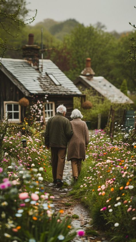 Elderly Couple Walking: An elderly couple takes a leisurely walk together along a flower-lined path near rustic cottages. #elderly #couple #walking #flowers #path #cottages #tranquility #village #aiart #aiphoto #stockcake https://ayr.app/l/pfoq Couple Gardening Together, Adventures For Couples, Couple Walking Photo, Couple Meditating Together, Elderly Aesthetic, Cottage Core Couple, Old Couples In Love, Old Couple Aesthetic, Cottage Couple