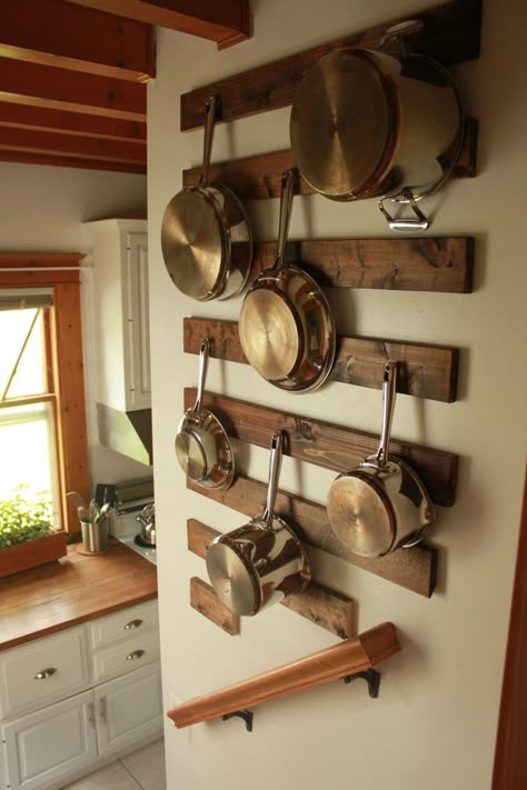 hanging pots and pans. nice way to protect the wall from the pots banging against the wall. Dapur Rustic, Organiser Cucina, Stove Kitchen, Kitchen Wall Storage, Pan Storage, Kabinet Dapur, Pantry Storage, Trendy Kitchen, Kitchen Remodel Idea