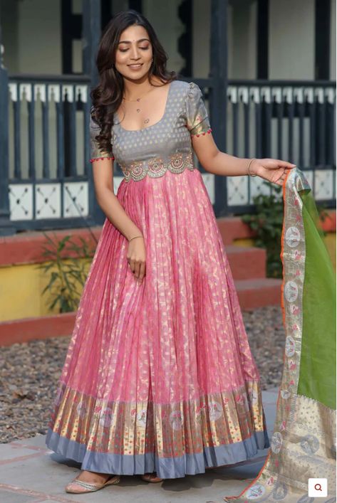 Kota Banarasi Silk Anarkali with Pethani Border and Maggam Worked Yoke Long gown for Festival occasion /partywear/ Wedding dress. Indulge in timeless elegance with this exquisite Zari Kota Banarasi Silk Anarkali. Crafted with intricate detailing and rich cultural heritage, this ensemble features a stunning Pethani border and meticulously hand-embellished Maggam work on the yoke. The puff sleeves add a touch of regal charm, while the delicate Net Dupatta drapes gracefully, completing the look. Wh Kota Anarkali Dress, Border Saree Dress Pattern, Banarasi Dress Pattern, Anarkali Dress With Saree, Traditional Gown From Saree, Kota Dresses Designs, Traditional Gown Designs, Frocks With Sarees, Silk Saree Gown Designs