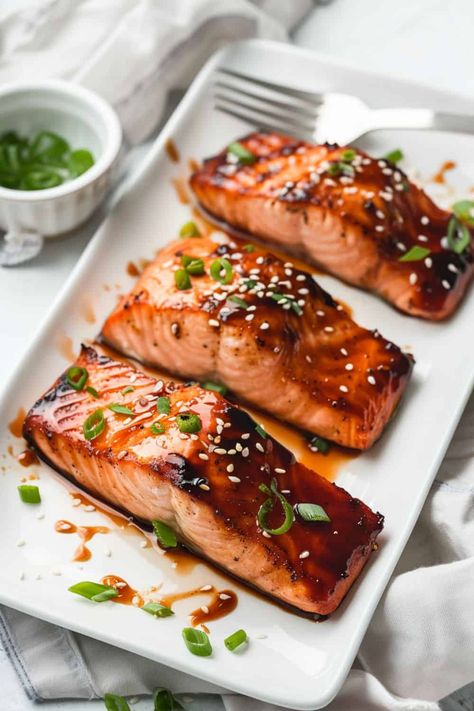 Three fillets of Teriyaki Salmon, beautifully seared with a golden exterior, glazed in a sweet and savory teriyaki sauce, making it a go-to recipe for a fast and flavorful dinner. Teriyaki Fish Recipes, Teriyaki Salmon Recipes, Terriyaki Salmon, Salmon With Teriyaki Sauce, Teriyaki Fish, Salmon Steak Recipes, Salmon Recipes Oven, Salmon Teriyaki, Salmon Teriyaki Recipe