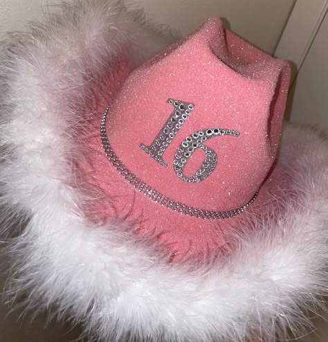 a handmade cowboy hat with whatever numbers you want on it! it's an adult size hat that is 5 inches tall and 25 inches in circumference. more information: hat color: you have the choice between a black, pink, white, or green hat string type: you have the choice between a black ribbon, a white ribbon, or a rhinestone bling string personalization: this is where you will enter what number(s) you want on the hat as well as the color of marabou boa you would like if you want something custom, want ad Cowgirl Hat Decorating Party, Cute Party Hats, 21 Cowboy Hat, Pink Cowgirl Hats, Classy Cowgirl Party, 21st Birthday Cowboy Hat Diy, Diy Cowgirl Hat Ideas Pink, Birthday Cowboy Hat, 21st Birthday Cowgirl Hat