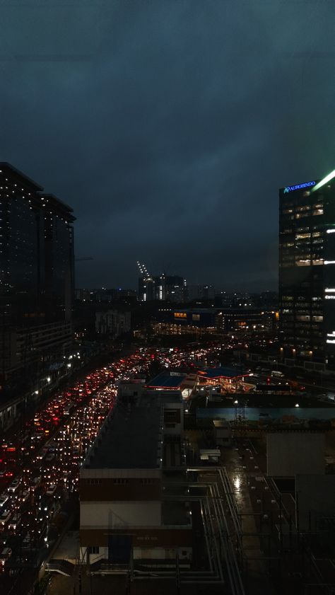 Dark and cloudy sky with rain in a metropolitan city. The roads shimmer in car lights with buildings on the side of the road. Hyderabad Hitech City, Hyderabad Night Life, Hyderabad Aesthetic Night, Bhubaneswar City Photography, Hyderabad Night View, Hyderabad Night Snaps, Hyderabad Night, Hyderabad Snaps, Hyderabad Aesthetic