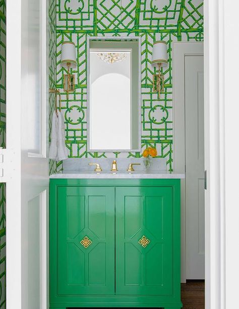 Eye-catching green bamboo trellis wallpaper complements a Kelly green washstand accented with brass hardware and a brass faucet kit fixed beneath a white bamboo mirror flanked by brass bamboo sconces. Kelly Green Bathroom, Beach Inspired Bathroom, House Beautiful Kitchens, House Beautiful Magazine, Bamboo Trellis, Trellis Wallpaper, Bamboo Mirror, Road Design, Green Bathroom