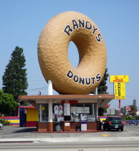 The original Randy's Donuts features the iconic donut, and been in countless movies including Mars Attacks!, and most recently Iron Man 2.  Good donuts and a great photo-op.    www.randysdonuts.com Randys Donuts, Big Donuts, Giant Donut, Googie Architecture, Inglewood California, California City, Vintage Los Angeles, Visit California, Los Angeles Usa