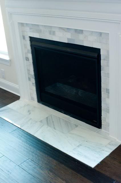 Fireplace Tile Surround Farmhouse, Grey Tile Fireplace Surround, Glass Tile Fireplace Surround, Fireplace Casing, Tiled Hearth Ideas, Marble Tile Fireplace Surround, Fireplace Floor Tile, Marble Tile Fireplace, Tile Fireplace Surround