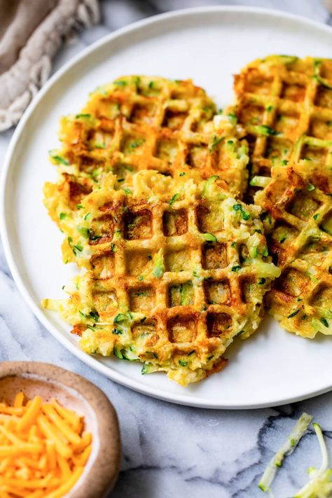 Dust off that waffle iron and make these zucchini waffles! It’s easy, super delicious, and a great way to use summer zucchini. #zucchini #waffle #sidedish #vegetarian #healthyrecipes #weightwatcherrecipes Zucchini Waffles, Zucchini Pancakes, Waffle Ingredients, Waffle Maker Recipes, Summer Zucchini, Savory Waffles, Easy Zucchini, Skinny Taste Recipes, Waffle Iron