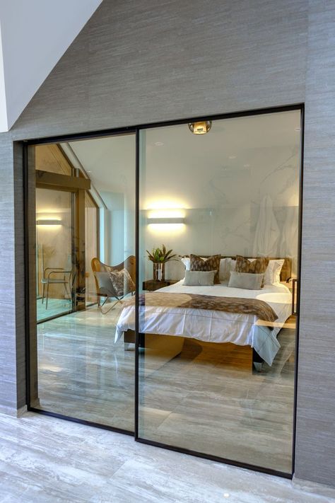 The slim framed sliding doors were specified with a bronze tinted glass, to offer privacy between the bedroom and bathroom whilst still benefitting from the full glass design. Internal Glass Sliding Doors, Interior Sliding Glass Doors, Bedroom Sets Furniture Queen, Glass Closet, Internal Sliding Doors, Bedroom Interior Design Luxury, Hampton House, House Extension Design, Door Design Interior