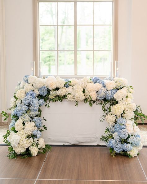 Loving the grandmillennial coastal blue style with a beautiful fusion of classic blue and white paired with lush, maximalist florals. This color palette truly captures the essence of summer Nantucket vibes, and I’m loving every bit of it! 🩵💙 @laurenpetersonphoto @isibealstudio @holliday_farms @aclassicpartyrental @abbybshealey #grandmillennialstyle #grandmillennialwedding #bluewedding #nantucketblues #hydrangeawedding Sweetheart Table Hydrangea, Hydrangea Flower Arrangements Wedding, White And Blue Wedding Florals, Nantucket Vibes, Blue Wedding Palette, July Wedding Ideas, July Wedding Flowers, Sweetheart Table Backdrop, Wedding Miscellaneous