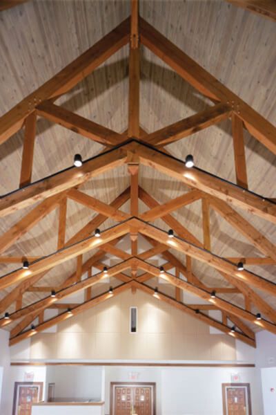 Heavy Timber - Triton Woods Exposed Beams Lighting, Exposed Trusses Lighting, Exposed Ceiling Lighting, Wood Truss Ceiling, Beam Ceiling Lighting, Exposed Steel Truss Ceiling, Open Truss Ceiling Exposed Rafters, Timber Truss Architecture, Truss Lighting