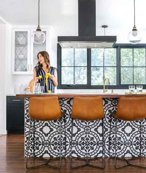 Keep It Simple  The kitchen island serves both as central gathering spot and style lodestar, with black-and-white cement tile that supplies the contemporary edge the couple was looking for. “Sometimes Spanish homes can feel weighty,” says Christina. “We wanted it to be young and fun.” In the kitchen, repurposed glass-front cabinets keep the mood light and airy, as does the new window the couple added over the sink. Cottage Kitchen Tiles, Spanish Style Homes, Spanish House, Diy Renovation, Kitchen Wallpaper, Kitchen Decorating, Kitchen Reno, Spanish Style, Kitchen Style