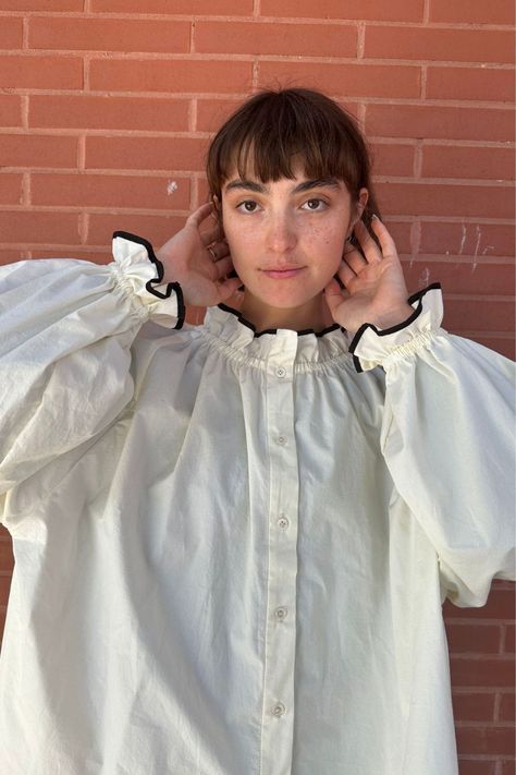 New arrivals for Fall. This best-seller is a universally flattering shape made from cream pre-washed poplin cotton, finished with jet black piping at the neck and sleeves. Nonbinary Fashion Feminine, Prague Summer, Summer Blouse Outfit, Blouse Sewing Pattern, Button Blouse, Eclectic Fashion, Cotton Blouse, Pearl Buttons, Sewing Inspiration