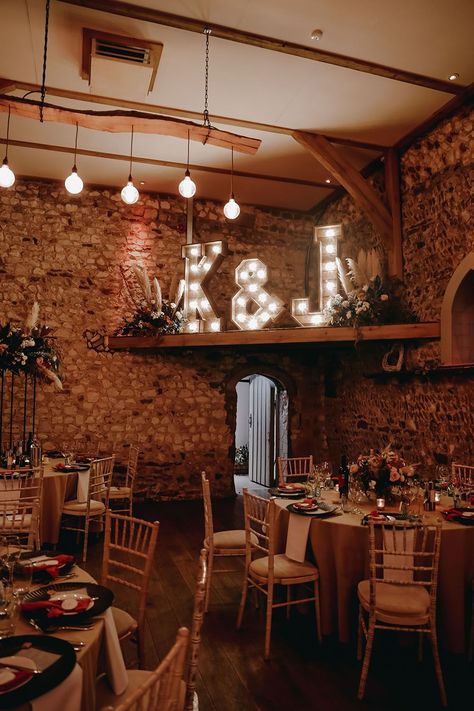 Rustic Pentney Abbey reception room with rounded tables and personalised light up letters against exposed brick Exposed Brick Wedding Reception, Exposed Brick Wedding, Event Space Decor, Brick Wedding Venue, Brick Wedding, Twinkle Lights Wedding, Christian Wedding Ceremony, Lighting Wedding, Abbey Wedding