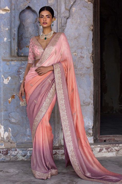 Peach to mauve ombre shaded lurex striped georgette embroidered with  gota, dabka and resham. Paired with georgette embroidered blouse and petticoat.
Components: 3
Pattern: Embroidered
Type Of Work: Gota, Dabka, Resham
Neckline: Plunge V
Sleeve Type: Elbow
Fabric: Saree: Lurex Georgette, Blouse: Georgette and Petticoat: Shantoon
Color: Peach,Purple
Other Details: 
Back tassel tie-up
Embroidered blouse
Occasion: Wedding,Reception - Aza Fashions Ombre Saree, Purple Saree, Bridal Lehenga Red, Classic Blouses, Indian Wedding Wear, Georgette Blouse, Blouse For Women, Georgette Sarees, Bridal Lehenga