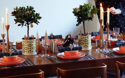 Orla Kiely's family Christmas table has been given a Mid-Century spin with retro patterned tableware in her signature prints. Miniature orange trees and wooden scandi style candlesticks complete the look. http://www.telegraph.co.uk/topics/christmas/11267627/Celebrating-a-family-Christmas-with-Orla-Kiely.html?frame=3124735 Family Christmas Table, Retro Christmas Table, Orange Trees, Table Table, Orange Tree, Orla Kiely, Scandi Style, Signature Print, Christmas Table Decorations