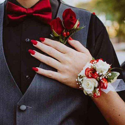 The red rose is the most commonly used symbol for love. If your wedding is filled with red roses, your family and friends with be inhaling love with every breath. #flowers #flowermeanings #symbol #flowersymbols #Floriography #flowerlanguage, #YourTango | Follow us on Pinterest: www.pinterest.com/yourtango Prom Corsage Red, Red Corsages, Prom Flowers Corsage, Prom Corsage And Boutonniere, Wrist Corsage Prom, Boutonnieres Prom, Prom Photoshoot, Prom Date, Corsage And Boutonniere