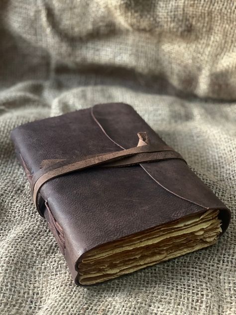 "Beautiful Cow Hide Leather Journals Soft and Durable Dark Brown Genuine Leather, - No glue used. - Hand Stitched. - Binding diary (paper is not refillable). - Real Leather scent. - Deckle Edge paper - each journal is very special Size - (length) 7\" x (Hight) 5\" x (width) 2\" inch. A perfect combination of luxurious leather cover and perfect quality paper. OUR DARK BROWN LEATHERBOUND NOTEBOOKS MAKE HEARTWARMING BIRTHDAY, ANNIVERSARY, VALENTINE'S, GRADUATIONS, ENGAGEMENT, WEDDING GIFTS, CHRISTM Leather Sketchbook Aesthetic, Leather Book Aesthetic, Old Leather Journal, Leatherbound Journals, Cool Journal Covers, Leather Journal Aesthetic, Men Journaling, Diy Leather Journal, Old Leather Book