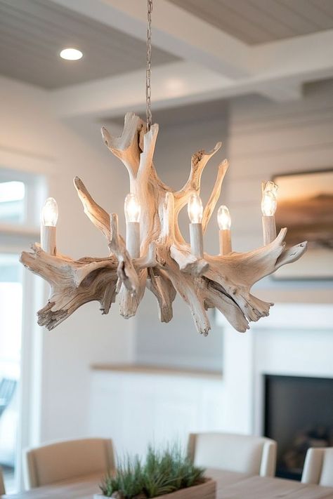 Create an eye-catching centerpiece in your dining or living room with a driftwood chandelier. This natural lighting fixture pairs beautifully with pastel decor and brings the essence of the beach into your home. Driftwood Light Fixture, Driftwood Light, Driftwood Centerpiece, Driftwood Chandelier, Driftwood Furniture, Pastel Decor, Natural Lighting, Light Fixture, Natural Light