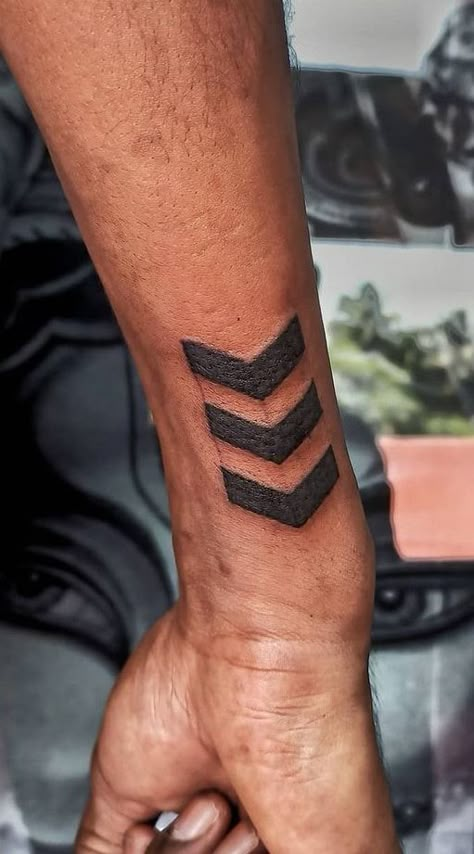 The Meanings Behind The Arrow Tattoo: A Growing Trend Side Arm Wrist Tattoo, Small Gym Tattoos For Men, Arrow On Wrist Tattoo, Arrow Tattoo Ideas Men, Mens Arrow Tattoo Forearm, Four Arrows Tattoo, Chevron Arrow Tattoo, Hand Arrow Tattoo, Men’s Wrist Tattoo Ideas