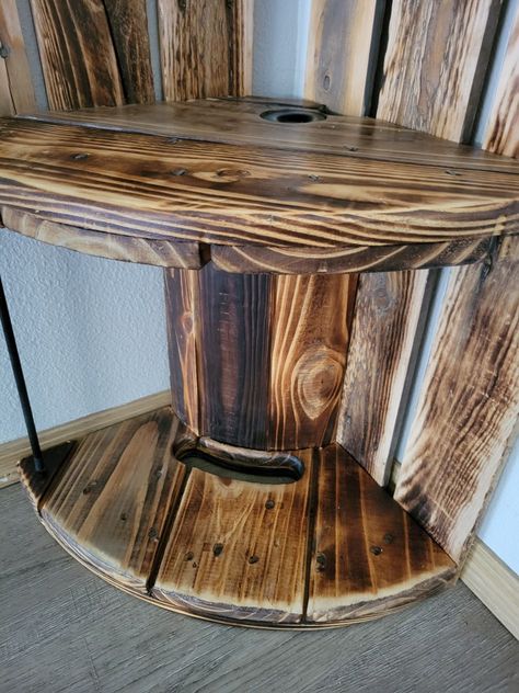 These were made by my kids and I. A truly unique and one of a kind set that would make a great statement piece in any room. Matching coffee table and corner shelf. Handmade from a rustic solid wood cable spool. Burnt wood with a high quality polyurethane finish. Coffee table: 26.5 inches wide x 18 inches tall. Corner shelf: 13 inch wide x 45 inches tall Coffee table: $200 Shelf: $150 Both: $300 Whiskey Corner, Diy Pallet Signs, Wood Spool Tables, Tall Corner Shelf, Tall Coffee Table, Whiskey Barrel Bar, Spool Table, Spool Tables, Cable Spool