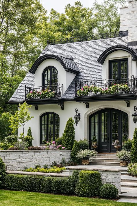 French white cottage with grey stone tile roof with dormers iron balconies with flowers stone brick foundations front yard with steps geometric. Ever wondered how white exterior houses manage to look both timeless and incredibly chic? Cottage Vibe House Exterior, Beautiful White Houses Dream Homes, Tudor Mansion Exterior, White Brick Mansion, White Exterior Homes, Modern Victorian House Exterior, Small Home Exterior, White Cottage Exterior, Stone Roof