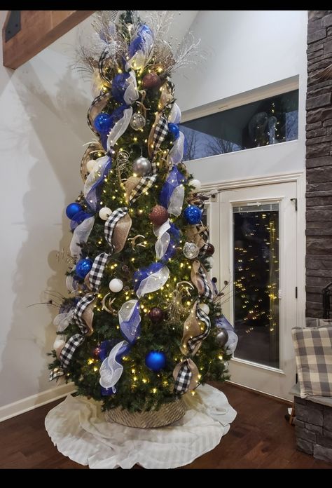 Our 12 ft Christmas Tree with blue and white mesh, buffalo plaid wide ribbon and burlap in wide also. Love how this turned out. #ChristmasTree #Christmas #ChristmasDecor #HolidayDecorations #DecoratingWithMesh Blue Buffalo Plaid Christmas Tree, 12 Ft Christmas Tree, Blue Christmas Tree Decorations, Navy Christmas, Buffalo Plaid Christmas Tree, Tree Themes, Blue Christmas Tree, Elegant Christmas Trees, Plaid Christmas Tree