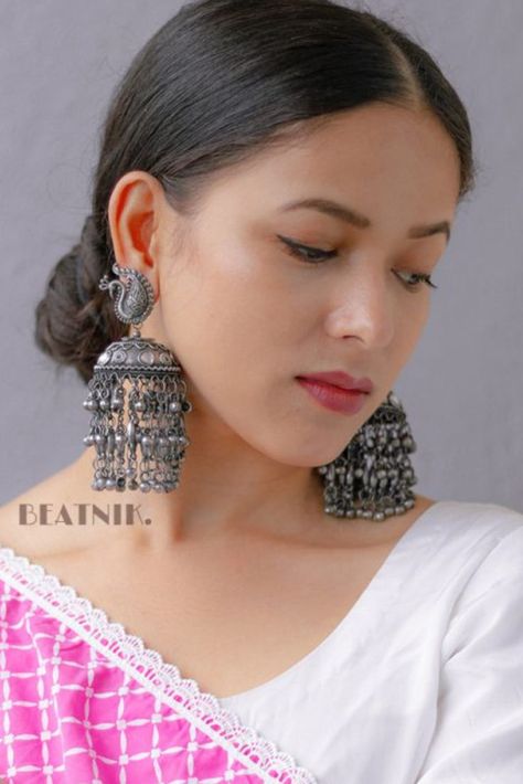 These exquisite jhumkis feature a playful peacock design in bold black metal, adding a touch of whimsy to your style. Big Earing, For Wedding Guest Outfit, Metal Peacock, Black Metal Jewelry, Ethnic Saree, Peacock Motif, Earrings For Wedding, Bridesmaid Saree, Peacock Earrings