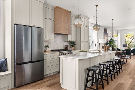 This Oak Park kitchen was the inspiration for Alison's June Picks, featuring bright sandy hues of Nantucket Bluff Shaker Cabinets, gold-veined Corsica Goldenrod Ultracompact Countertops, and additional sparks of bling in the Gracious Home Custom Hardware and Moen brushed gold faucet. Kitchen Island With Sink Decor, Cabinets To Go, Kitchen Island With Sink, Sleek Cabinet, Sink In Island, Sink Decor, Free Kitchen Design, Plywood Shelves, Stock Cabinets